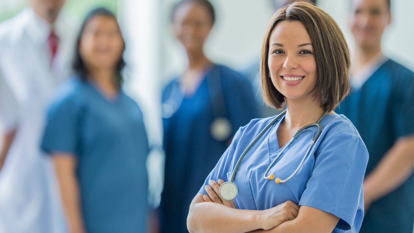 nurse wears a scrub uniform color green branded with unis on the go brand